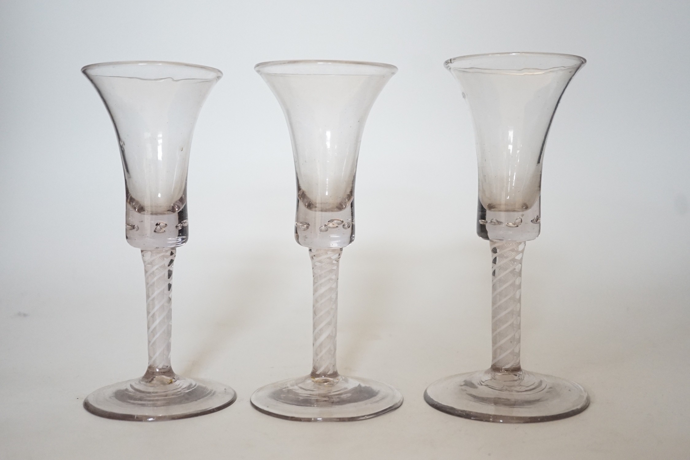 A trio of George III style cotton twist stemmed glasses, 17.5cms high